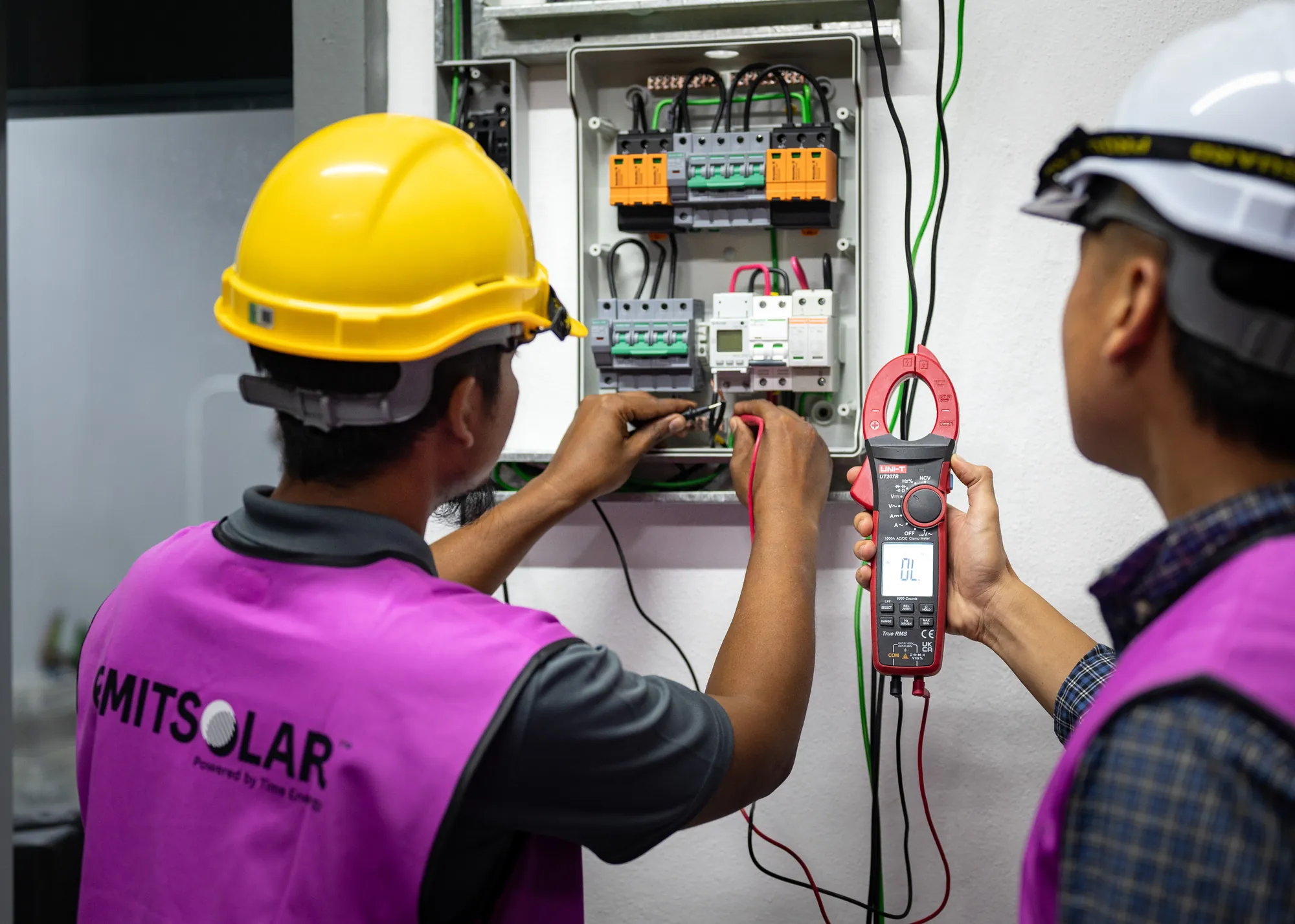 Installers testing the system at the distribution board